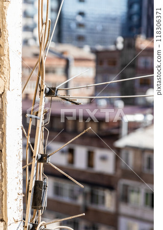 television and radio antennas on wall of house 118306371