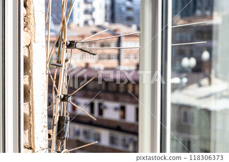 antennas on shabby wall of urban house close up 118306373