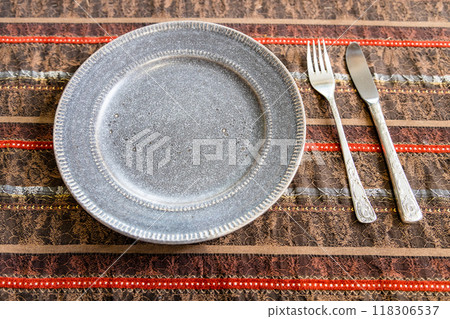 brown ceramic plate with fork and table knife 118306537