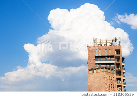 white clouds in blue sky and apartment buildings 118306539