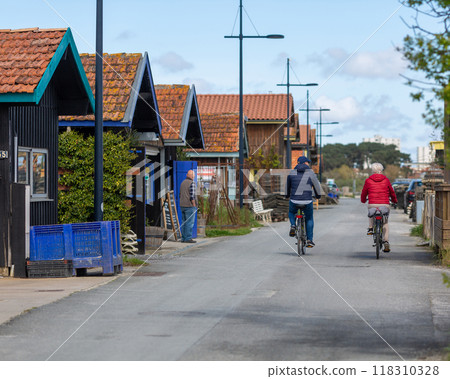 Person riding a bicycle on a cycle path 118310328
