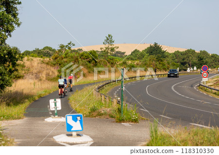 Person riding a bicycle on a cycle path 118310330
