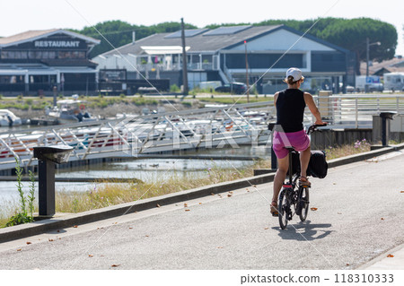 Person riding a bicycle on a cycle path 118310333