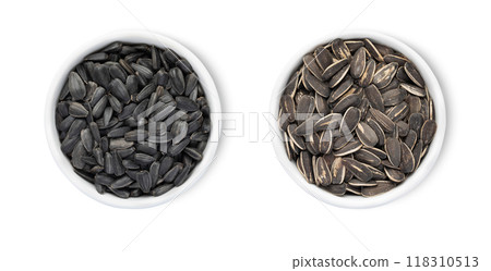 Bowl plates with healthy black sunflower seeds with shell isolated on white background.Top view. 118310513