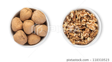 Bowls with organic walnut nuts isolated on white background.Top view. 118310523