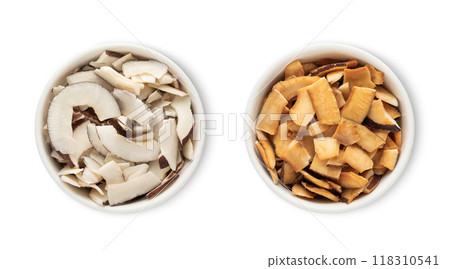 Bowl plates with sweet dried organic coconut pieces isolated on white background.Top view. 118310541