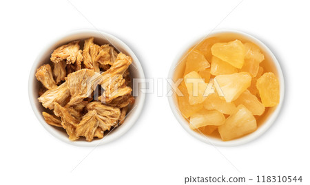 Bowl plates with sweet dried pineapple pieces isolated on white background.Top view. Bowl plates with sweet dried pineapple pieces isolated on white background.Top view. 118310544
