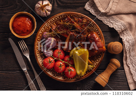 Grilled pork ribs with vegetables on dark wooden background 118310602