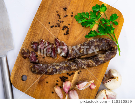 Cured pork sausage with condiments on cutting board 118310839