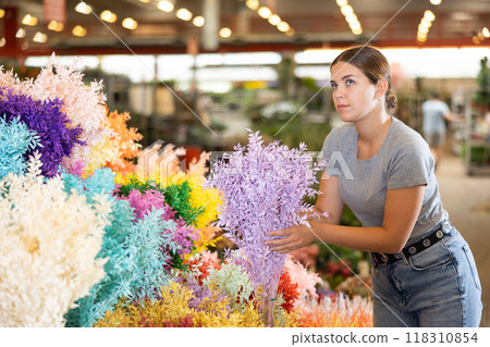 Female shopper chooses Ruscus Italie flowers for a bouquet at flower market Female shopper chooses Ruscus Italie flowers for a bouquet at flower market 118310854
