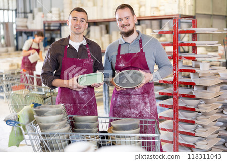 Two men posing with ceramic dishes Two men posing with ceramic dishes 118311043