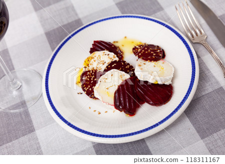 Fresh baked beetroot and goat cheese salad on plate and decorated with sesame seeds. Healthy concept Fresh baked beetroot and goat cheese salad on plate and decorated with sesame seeds. Healthy concept 118311167