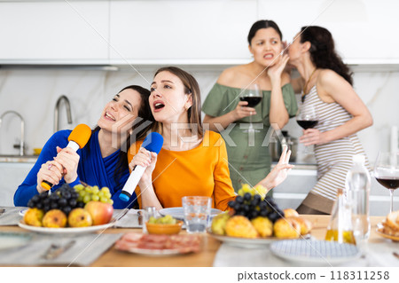 Group of female friends are having fun singing karaoke during feast and gatherings. 118311258