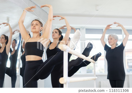 Elderly woman teacher shows ballet moves Elderly woman teacher shows ballet moves 118311306