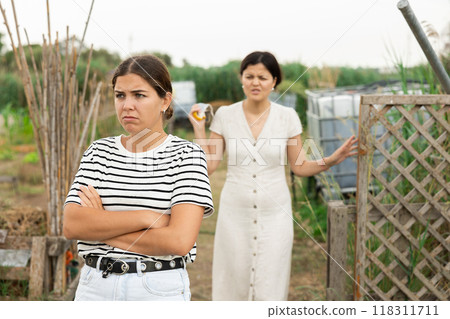 Farm neighbors quarrel over farm backyard in day Farm neighbors quarrel over farm backyard in day 118311711