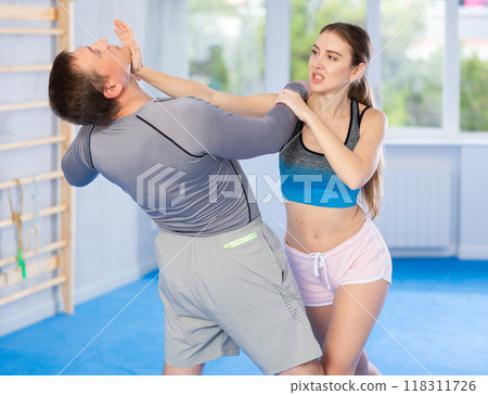 Woman and man practicing self defense techniques Woman and man practicing self defense techniques 118311726