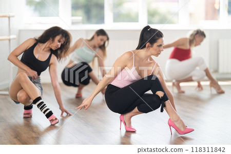 Woman performing modern high heels choreography at dance class 118311842