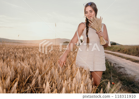 Woman in White Dress Holding Wheat in a Field 118311910