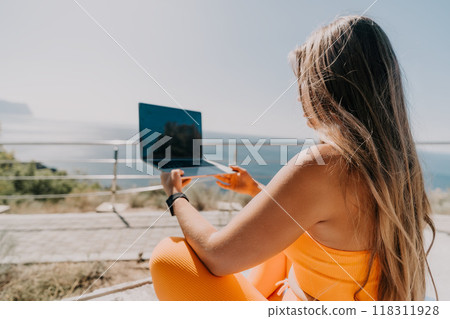 Woman Working on Laptop With Ocean View 118311928