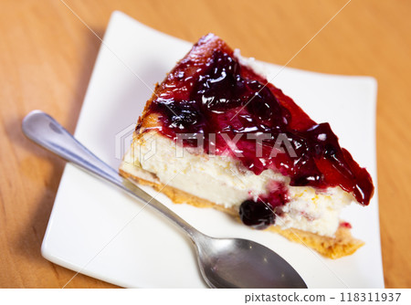 Piece of cranberries cheesecake, drizzled with jam on top Piece of cranberries cheesecake, drizzled with jam on top 118311937