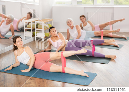 Young woman exercising with pilates band Young woman exercising with pilates band 118311961