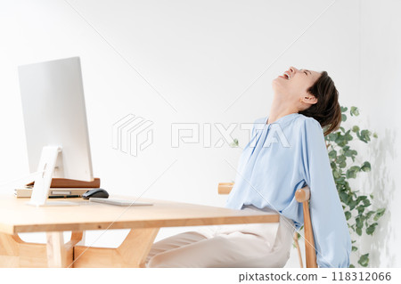 Woman leaning on chair due to trouble Woman leaning on chair due to trouble 118312066