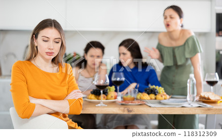 Group of women quarreling with young woman Group of women quarreling with young woman 118312309