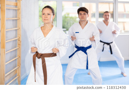 Athletes have starting position and repeating sequence of punches and painful techniques in kata 118312430