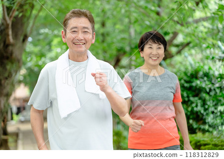 Senior couple jogging, fresh greenery Senior couple jogging, fresh greenery 118312829