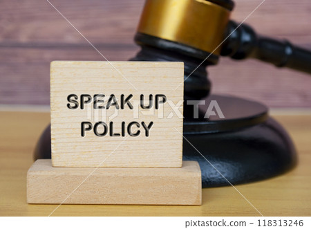 Speak up Policy text engraved on wooden blocks with gavel background. Courage and speak up policy concept Speak up Policy text engraved on wooden blocks with gavel background. Courage and speak up policy concept 118313246