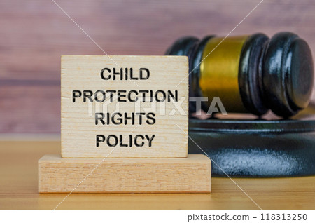 Child Protection Rights Policy text engraved on wooden blocks with gavel background Child Protection Rights Policy text engraved on wooden blocks with gavel background 118313250