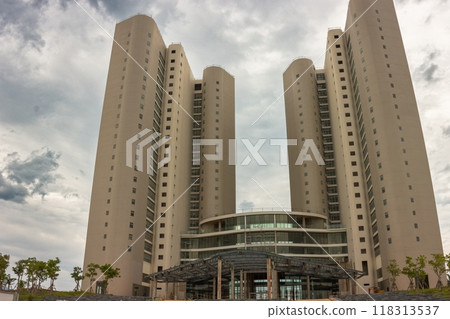 Beautiful multistorey building against the background of clouds 118313537