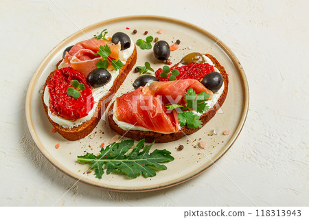 sandwiches with cheese and prosciutto, dried tomatoes and olives, breakfast on a plate, 118313943