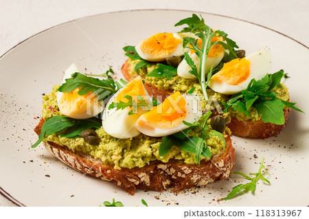 sandwich with mashed avocado, boiled egg, and arugula, on bread , homemade, breakfast, 118313967