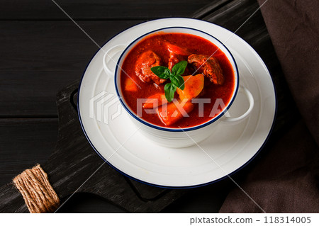 Stew with potatoes, in tomato sauce, with spices and herbs, close-up, no people, on a black background 118314005