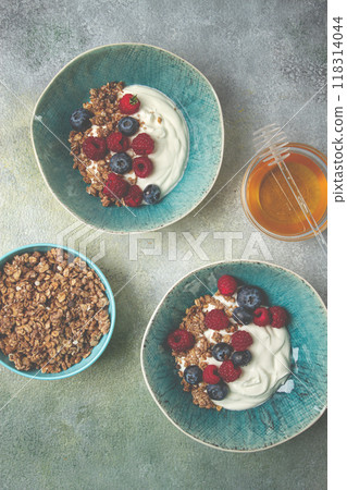 Breakfast, two bowls, yogurt, muesli with berries, and honey, homemade, no people, 118314044