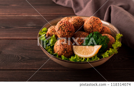Chickpea falafel balls, on a wooden table, close-up, vegetarian food, 118314074
