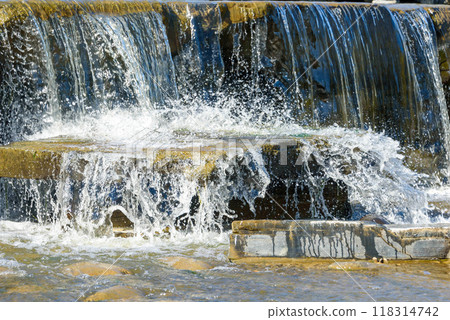 Water splashes in an artificial cascading waterfall. 118314742