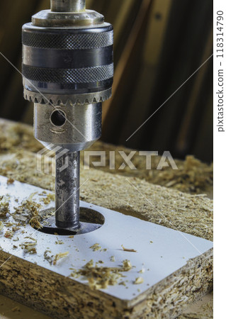 Drilling holes in the particle board 118314790