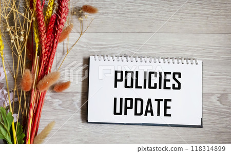 The policy update message is written on a notepad with a beautiful background. The policy update message is written on a notepad with a beautiful background. 118314899