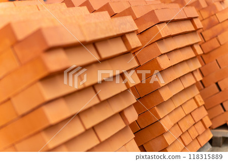 Stacks of new, red ceramic brick stacked on wooden pallets. Stacks of new, red ceramic brick stacked on wooden pallets. 118315889