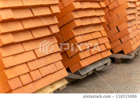 Stacks of new, red ceramic brick stacked on wooden pallets. Stacks of new, red ceramic brick stacked on wooden pallets. 118315890