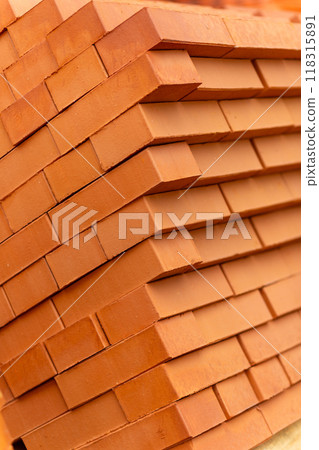 Stacks of new, red ceramic brick stacked on wooden pallets. Stacks of new, red ceramic brick stacked on wooden pallets. 118315891