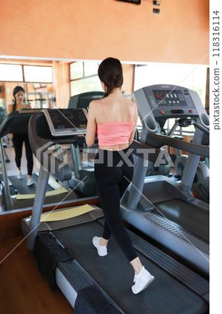 Woman On The Treadmill Using Smartphone  118316114