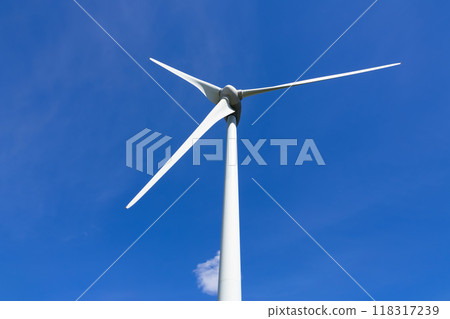 Close-up of a wind turbine on the background of blue sky with a cloud. 118317239