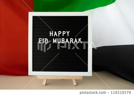 Congratulations with text HAPPY EID MUBARAK - happy holidays waving UAE flag on background concept. Greeting card advertisement. Commemoration Day Muslim Ramadan Blessed holy month public holiday Congratulations with text HAPPY EID MUBARAK - happy holidays waving UAE flag on background concept. Greeting card advertisement. Commemoration Day Muslim Ramadan Blessed holy month public holiday 118318579