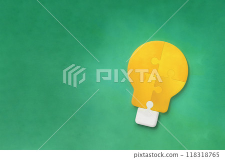 A light bulb-shaped puzzle object on a green background 118318765