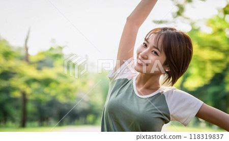 Young woman stretching in the park. 118319837