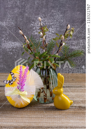 Wooden table with Easter bunny, egg and bunch of willow. Wooden table with Easter bunny, egg and bunch of willow. 118321767