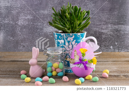 Succulent in a cup, Easter decorated egg, candies and bunny. 118321773